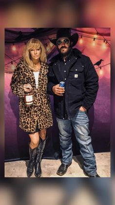 a man and woman standing next to each other in front of a wall with lights