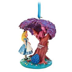 an ornament shaped like a tree with alice and wonderland characters hanging from it