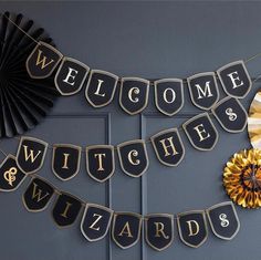 welcome witches and wizards banner hanging on the front door with fan, mirror and decorations