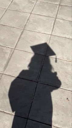 a shadow of a person holding an umbrella