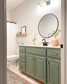 Bathroom vanity green gold subway tile black faucet round mirror Jewel Green Bathroom Vanity, Mint And Gold Bathroom, Pop Of Color Bathroom Vanity, Left Offset Bathroom Vanity, Bathroom Vanity Paint Colors, Sage Green Bathroom Vanity, Green Cabinets Bathroom, Leaf Bathroom