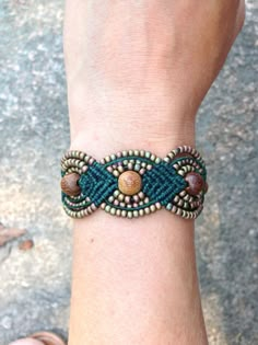 a person wearing a bracelet with beads on their wrist