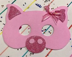 a pink pig mask with glitter on it