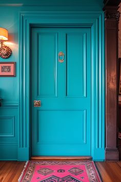 a bright blue door with a pink rug on the floor