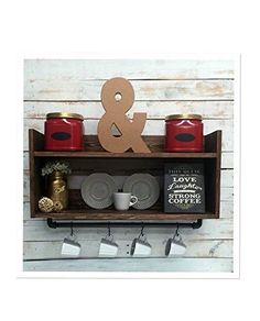 a shelf that has some cups and saucers on it with the word & amp above it