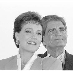 a man and woman are posing for a black and white photo