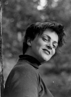 an old black and white photo of a woman leaning against a tree with her eyes closed