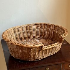 a wicker basket sitting on top of a wooden table