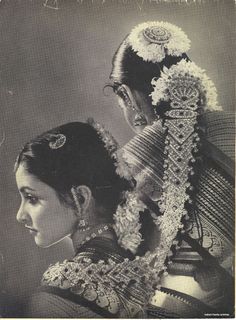 an old photo of a woman with flowers in her hair and jewelry on her head