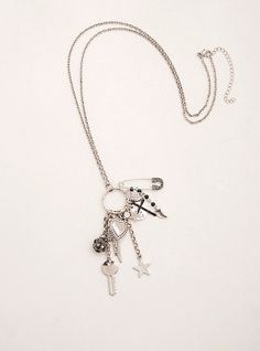 Everything a goth gal loves, all on one necklace! This mid silver tone chain rocks steady with rock 'n' roll charms - from a bedazzled safety pin, to skulls, to a lightning bolt. Lobster clasp. 31. 5” long with 3” extender. Base metals. Imported. The best plus size women's skull safety pin charm necklace necklaces in silver. Torrid is your destination for cozy fall and winter clothes to keep you warm and comfortable. Emo Style Jewelry With Adjustable Chain For Concerts, Silver Emo Necklace For Concert, Silver Emo Necklace For Concerts, Edgy Silver Jewelry With Charms, Rock Steady, Lightning Bolt, Cozy Fall, Safety Pin, Base Metal