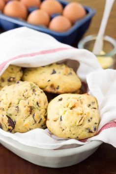 a bowl filled with cookies next to some eggs