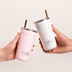 two people holding coffee cups with the same color