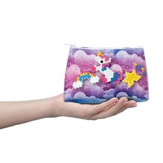 Aquabeads Decorator's Pouch is a complete craft set using beads and templates to design a unique purse with an out of this world pink unicorn theme! Set includes over 500 solid, jewel and star shaped beads in a variety of colors, along with templates, layout tray and sprayer! Everything you need to begin crafting with Aquabeads, including unique pink galaxy design pouch with top zipper closure. Simply create your bead designs following the template, and then use the design pegs to attach designs Handmade Multicolor Pencil Case For Crafting, Handmade Multicolor Pouch For Crafting, Multicolor Handmade Crafting Pouch, Handmade Multicolor Crafting Pouch, Mystical Unicorn, Pouch Diy, Pink Galaxy, Unicorn Theme, Unique Purses