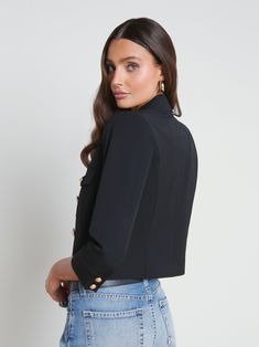 The Kumi is our modern update to the classic three-quarter sleeve jacket. A strong shoulder and tapered silhouette create flattering definition. This easy, goes-with-everything style is crafted from a supple stretch-suiting fabrication and finished with flap pockets and our signature gold embossed dome buttons. Pair with high-waisted denim for a perfectly proportioned look. | L'AGENCE Kumi Cropped Jacket In Black Elegant Formal Blazer With 3/4 Sleeves, Elegant 3/4 Sleeve Blazer For Formal Occasions, Black Double-breasted Cropped Jacket For Work, Classic Formal Outerwear With 3/4 Sleeves, Elegant Black Cropped Jacket With Button Closure, Chic Office Blazer With 3/4 Sleeves, Fitted Formal Outerwear With 3/4 Sleeves, Classic Formal Blazer With 3/4 Sleeve, Elegant Outerwear With Button Closure, 3/4 Sleeve