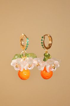 "Positano flower and orange hoop earrings, glass clementine drop earrings, food earrings, fruit earrings, gold summer custom earrings Inspired by Positano in Italy, these lovely little earrings are perfect for giving your outfit a taste of summer. The hoop is a 24k gold-plated earring, studded with small green zircons. Hanging from the hoop are pretty Czech crystal white flowers, green leaves, and at the bottom, an orange, also made of Czech crystal. Floral and fruity, these earrings smell like Summer Orange Flower-shaped Jewelry, Summer Orange Drop Earrings, Orange Flower-shaped Earrings For Summer, Orange Flower Shaped Earrings For Summer, Summer Orange Jewelry With Fruit Design, Orange Fruit Design Earrings As Gift, Earrings Food, Hippie Nails, Orange Outfit