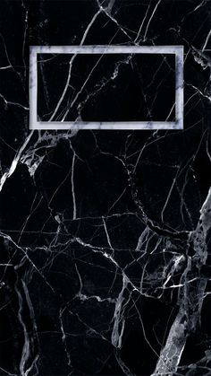 a black marble wall with a white frame