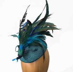 Small Peacock hat. Teal green color with peacock feathers and sinamay ribbons. Teardrop shaped pillbox style hat. Elegant and fun! Peacock Fascinator, Peacock Hat, Hats And Fascinators, Teal Green Color, Suit Ideas, Blue Peacock, Designer Hats, Peacock Feathers, Wedding Hats