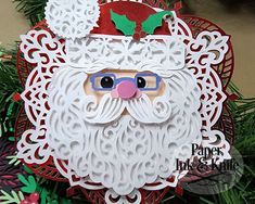 a close up of a christmas ornament with a santa clause on it's face