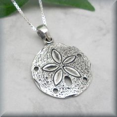 "A beautifully detailed sand dollar pendant is simple and stunning in this beach necklace. This is the perfect necklace for summer! Sterling silver box chain. Pendant is 5/8\" round (1.59 cm). All components are sterling silver. Coordinating earrings for this piece can be found here: https://www.etsy.com/listing/191376144/sanddollar-earrings-sterling-silver-sand?ref=shop_home_active_4 Jewelry is packaged in a cotton lined box for gift-giving. See more Bonny Jewelry at http://bonnyjewelry.etsy.co Beach Pendant Jewelry With Engraving, Beach Engraved Pendant Jewelry, Silver Engraved Necklace For Beach, Beachy Silver Strand Jewelry, Silver Coastal Jewelry For Beach, Coastal Style Silver Jewelry For Beach, Beachy Silver Vacation Jewelry, Silver Starfish Charm Necklace For Summer, Silver Starfish Jewelry For Vacation