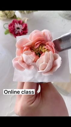 a person is using a knife to cut paper flowers