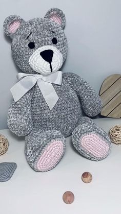 a crocheted teddy bear sitting on top of a table