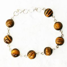 925 sterling silver jewelry bracelet studded with Natural Tiger Eye gemstone, handmade jewelry with beautiful November birthstone, wholesale prices, fashion jewelry Gift For Women, bracelet stamped with its purity, can be customized as per your style, Christmas Gift ABOUT TIGER'S EYE :- Tiger Eye is a birthstone for those born in November. Tiger Eye is a stone of luck, prosperity and good fortune. Tiger Eye symbolize courage, integrity and right use of power. Tiger Eye is a warm stone and powerf Sterling Silver Jewelry Bracelets, Tiger Eye Bracelet, Tigers Eye Gemstone, November Birthstone, Birthstone, 925 Sterling Silver Jewelry, Tiger Eye, Birthstone Jewelry, Handmade Bracelets