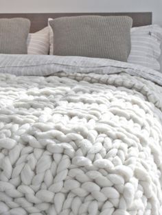 a bed with white blankets and pillows on top of it, in the middle of an instagram page