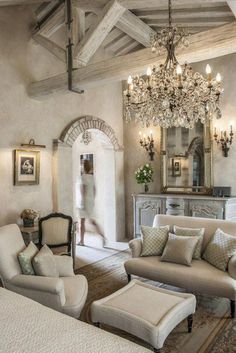 a living room filled with furniture and a chandelier