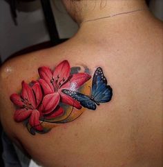 a woman with a butterfly and flowers tattoo on her back