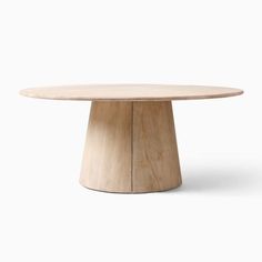 a round wooden table sitting on top of a white floor