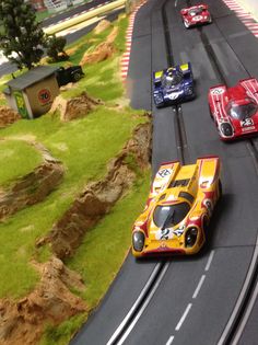 three toy cars are racing on a track