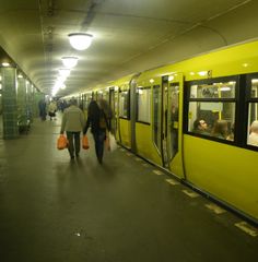 people are walking down the subway platform