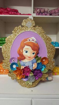 an image of a princess with flowers on it's head in the center of a shelf