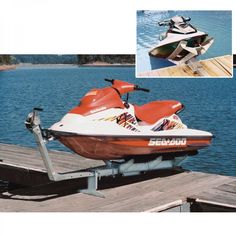 a red and white jet ski parked on top of a wooden dock