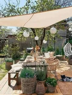 an outdoor dining area with wicker furniture and plants