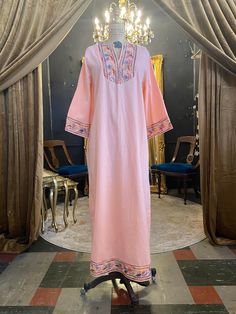 "Vintage 1970s kaftan 70s maxi dress Peach cotton V-neck Bell sleeves Swirling rainbow embroidery on the bib, cuffs and hem Zips up the back Very good vintage condition Size medium Bust 36/38\" Hips best to 43\" Length 51\"" Pink Embroidered Long Sleeve Maxi Dress, Bohemian Peach Maxi Dress For Vacation, Pink Long Sleeve Embroidered Maxi Dress, Bohemian Peach Maxi Dress For Beach, Pink Floor-length Kaftan For Spring, Pink Floor-length Spring Kaftan, Embroidered Maxi Length Pink Kaftan, Pink Embroidered Maxi-length Kaftan, Embroidered Pink Maxi Kaftan