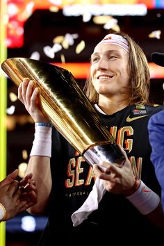 a man holding a trophy in his right hand