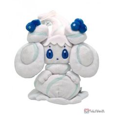 a white stuffed animal with blue eyes and ears