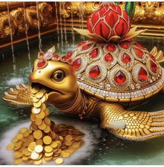 a golden turtle statue sitting on top of a pile of gold coins