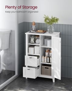 a white bathroom cabinet with drawers and baskets