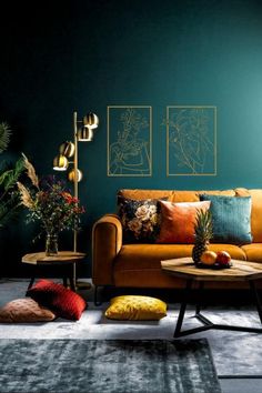 a living room filled with furniture and colorful pillows on top of each other in front of a blue wall