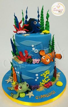 a blue cake decorated with sea animals and fish