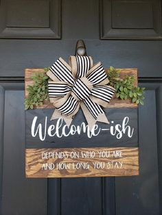 a welcome sign hanging on the front door