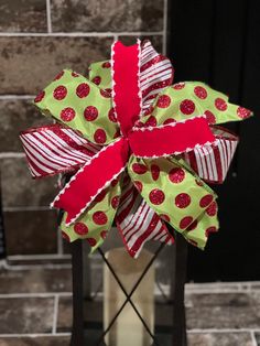 a green and red bow with polka dots on it