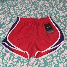 Reddish Orange With Purple And White Striped Detail On Sides, Adjustable Draw Strings, Lined, Elastic Waist , New With Tags! Nike Red Athletic Shorts, Nike Red Sporty Shorts, Nike Red Sporty Athletic Shorts, Nike Sporty Red Athletic Shorts, Red Nike Workout Bottoms, Nike Red Workout Shorts, Red Stretch Nike Athletic Shorts, Nike Red Stretch Athletic Shorts, Nike Athletic Shorts