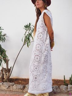 a woman in a white dress and brown hat