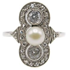 Charming Art-Deco 14 karat white gold diamond and pearl ring, centrally set with one white round pearl and flanked by 2 Old European Cut diamonds. Surrounding these, in a mill-grain bezel are 24 rose cut diamonds and another rose cut diamond on the top of each shank. Size 7.5. Can be resized Item Number O575 Diamond And Pearl Ring, Pearl Gold Ring, Antique Rings Victorian, Art Nouveau Ring, Pearl Engagement Ring, Art Deco Diamond Rings, Vintage Diamond Rings, Citrine Ring, Deco Jewelry