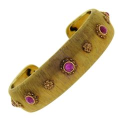 Magnificent 18K gold cuff by Buccellati featuring ruby cabochons. DESIGNER: Buccellati MATERIAL: 18K Gold GEMSTONE: Ruby DIMENSIONS: Cuff measures 16.1mm wide and will fit up to 6.5" wrist. WEIGHT: 23.2 grams MARKED/TESTED: Buccellati, 750, Italy CONDITION: Estate PRODUCT ID: 16824 Luxury Gold Ruby Bracelets, Formal Yellow Gold Ruby Bangle, Buccellati Jewelry, Ruby Bangles, Gold Cuff Bracelet, Ruby Bracelet, Yellow Gold Bangle, Vintage Bangles, Solitaire Pendant Necklace