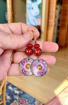 Sweet As.  Appealing and eye catching enamel wheels made bold with juicy deep red dotted beads from my secret stash.  14k gold filled earwire. Handmade Red Enamel Jewelry, Hand-painted Red Jewelry For Valentine's Day, Hand Painted Red Jewelry For Valentine's Day, Handmade Enamel Jewelry For Valentine's Day, Adjustable Hand-painted Red Jewelry, Adjustable Hand Painted Red Jewelry, Adjustable Red Hand-painted Jewelry, Adjustable Red Hand Painted Jewelry, Red Heart-shaped Hand Painted Jewelry