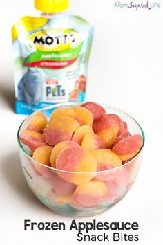 a bowl filled with frozen apples next to a bag of mott's